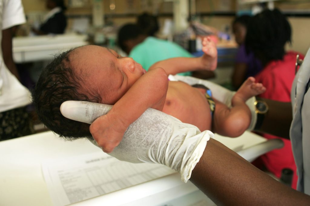 Nurse caring for a newborn in Malawi