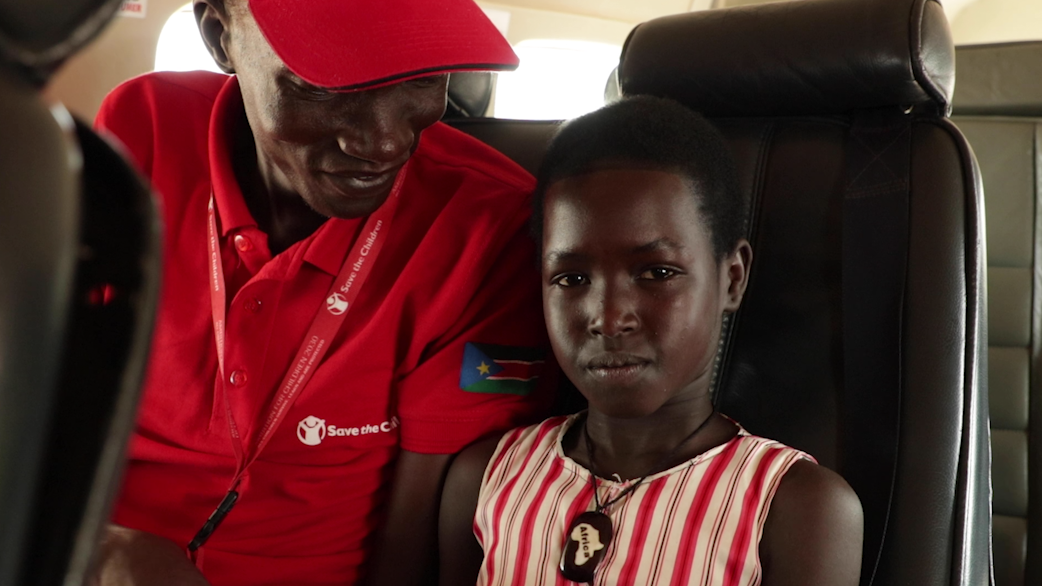 Save the Children Case Worker, Zacharia Manyang, making Asha* comfortable on the way to meet her mother after 5 years of separation